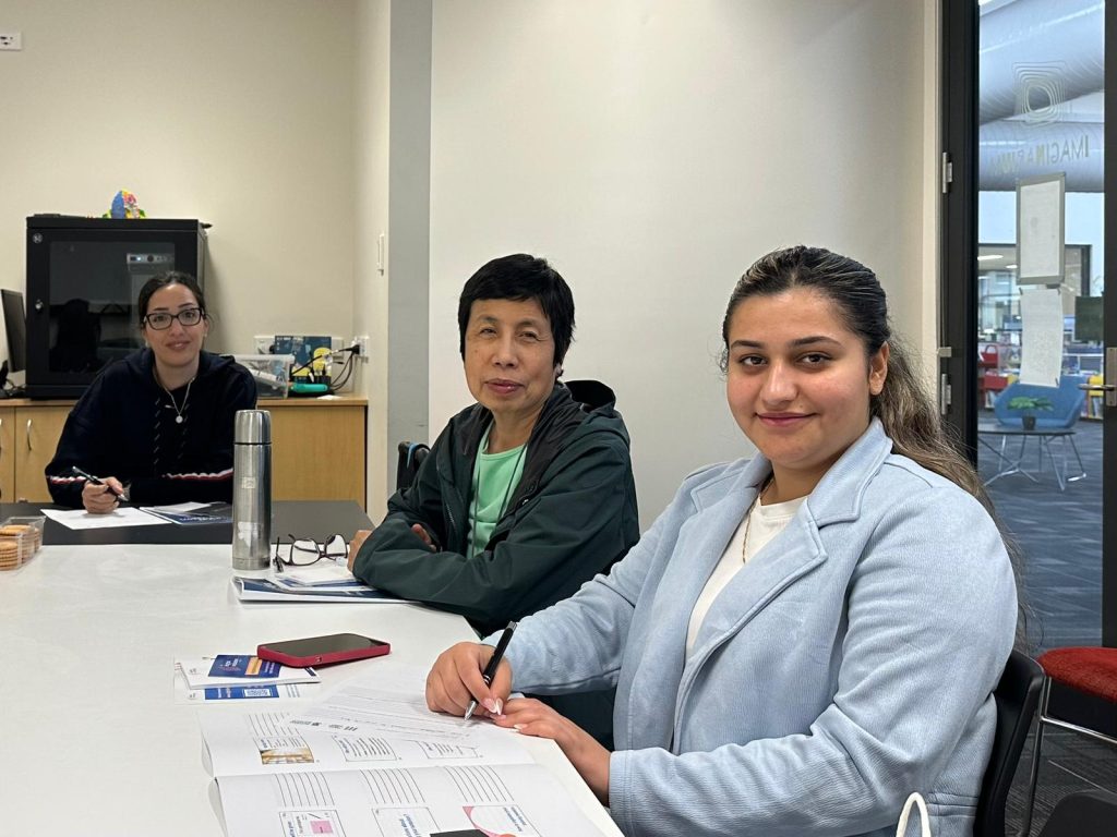 three women sitting around a table